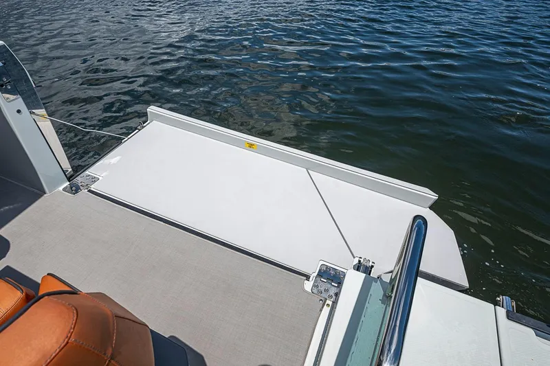 Slide: The Image of 2023 Saxdor 320 GTO boat with open swim platform on calm water. - 12