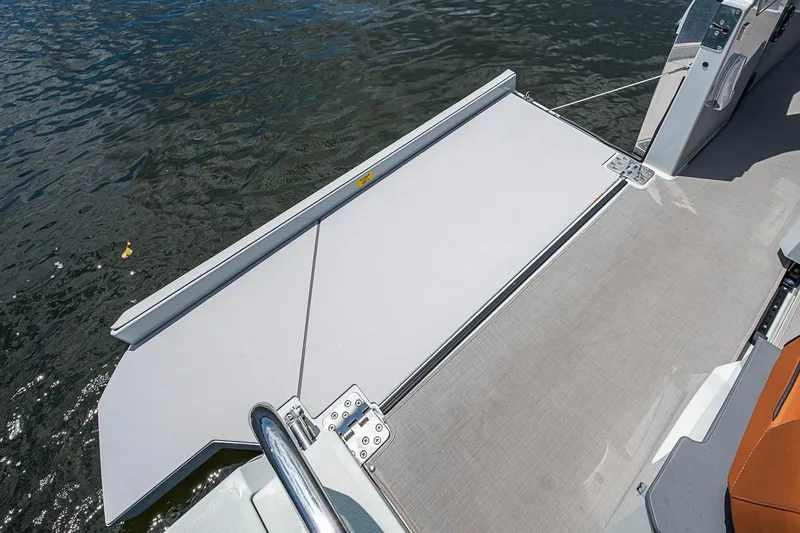 Slide: The Image of 2023 Saxdor 320 GTO boat deck with water view and sleek design. - 13