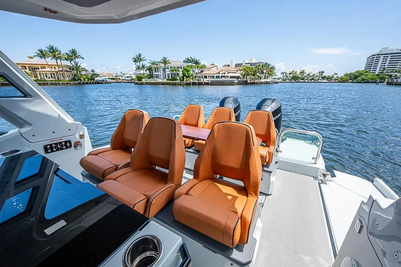 Slide: The Image of 2023 Saxdor 320 GTO boat interior with luxurious seating and scenic waterfront view. - 19