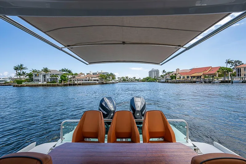 Slide: The Image of 2023 Saxdor 320 GTO boat with dual engines, scenic waterfront view. - 21