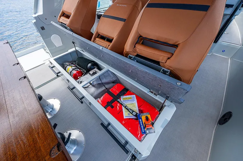 Slide: The Image of Storage compartment in 2023 Saxdor 320 GTO boat with safety equipment and accessories. - 25