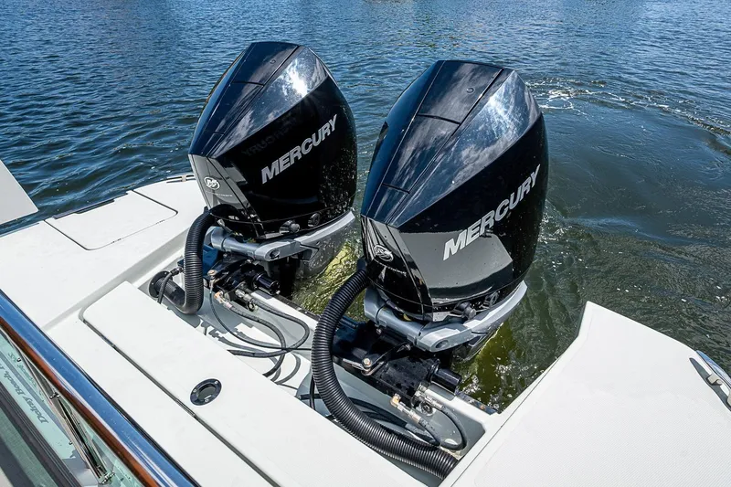 Slide: The Image of Twin Mercury outboard engines on a 2023 Saxdor 320 GTO boat, cruising on water. - 27