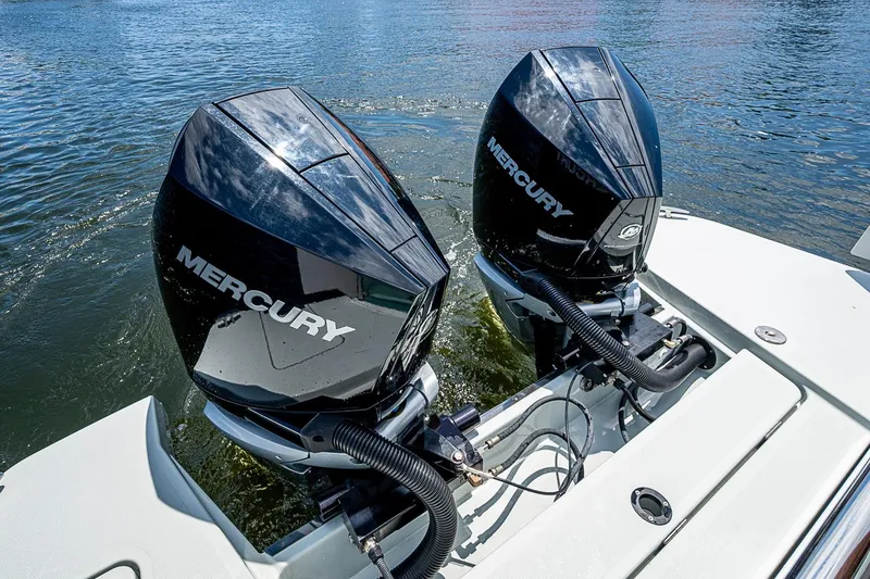 Slide: The Image of Twin Mercury outboard engines on a 2023 Saxdor 320 GTO boat in water. - 28