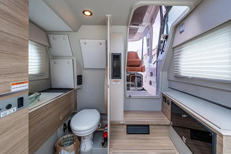 Slide: The Image of Interior of 2023 Saxdor 320 GTO boat featuring modern bathroom and sleek design elements. - 32