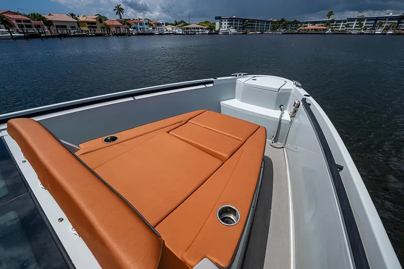 Slide: The Image of 2023 Saxdor 320 GTO boat with orange seating, docked near waterfront homes. - 8