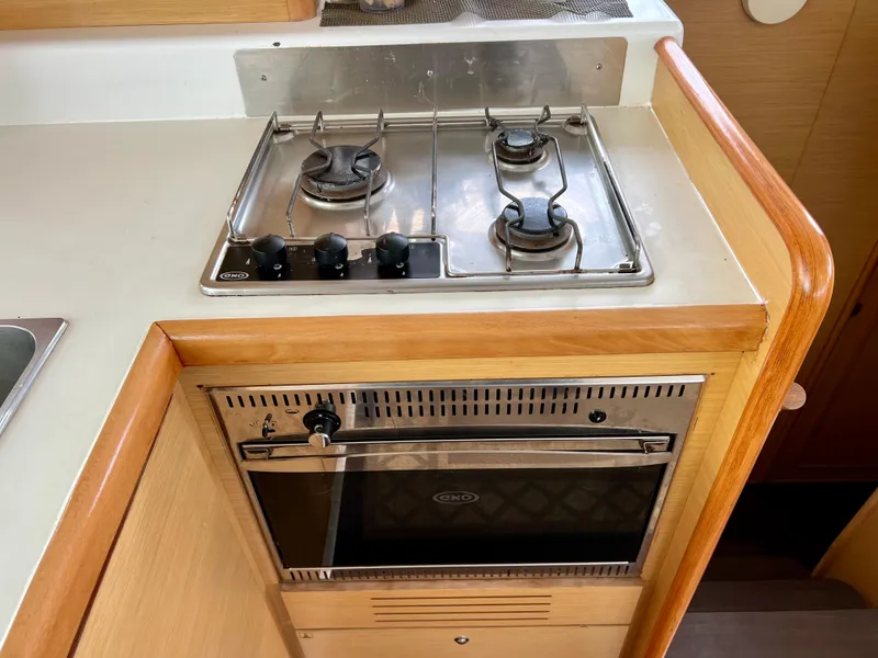 Slide: The Image of Kitchen area of a 2008 Lagoon 420 yacht with stove and oven. - 17