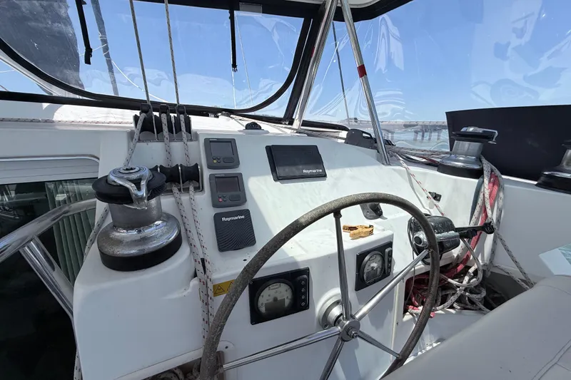 Slide: The Image of Cockpit of 2008 Lagoon 420 sailboat with steering wheel and navigation instruments. - 2