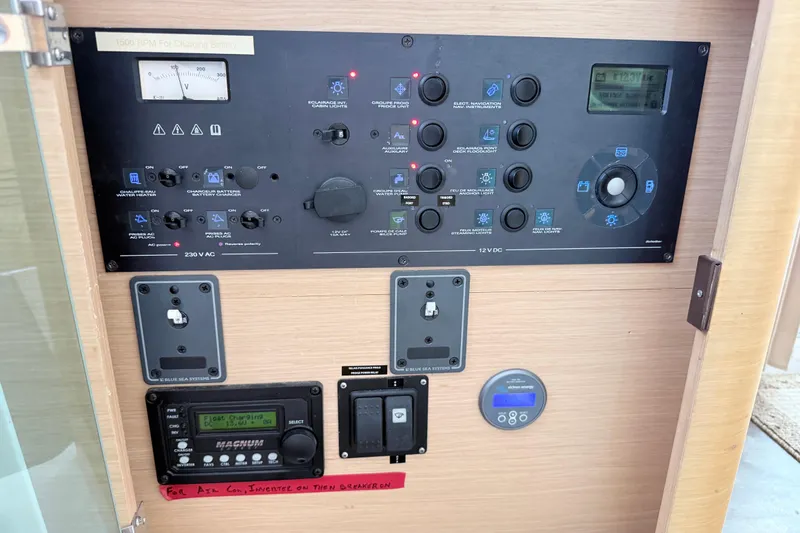 Slide: The Image of Control panel of a 2008 Lagoon 420 yacht, featuring various switches and displays. - 22
