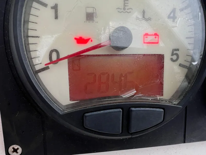 Slide: The Image of Close-up of a Lagoon 420 boat gauge showing 2845 hours with warning lights. - 24