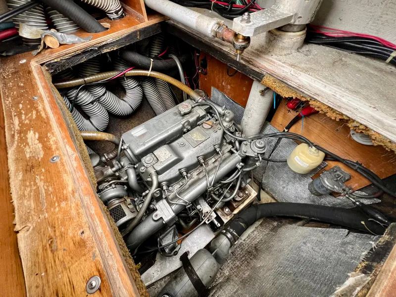 Slide: The Image of Engine compartment of a 2008 Lagoon 420 sailboat, showcasing mechanical components and wiring. - 26