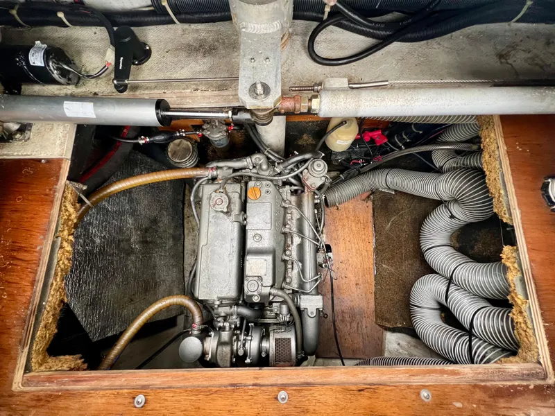 Slide: The Image of Engine compartment of a 2008 Lagoon 420 sailboat, showcasing mechanical components and wiring. - 28