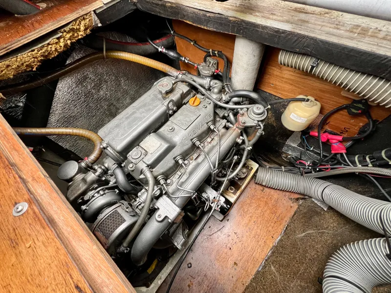 Slide: The Image of Engine compartment of a 2008 Lagoon 420 sailboat, showcasing mechanical components and wiring. - 29