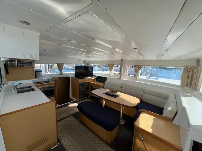 Slide: The Image of Interior of 2008 Lagoon 420 catamaran with modern kitchen and cozy seating area. - 3