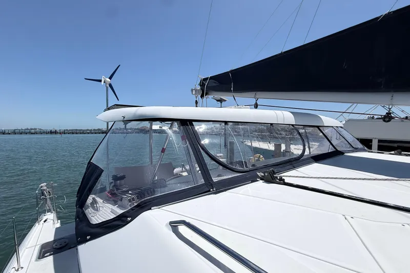 Slide: The Image of 2008 Lagoon 420 catamaran with wind turbine, docked on a sunny day. - 33