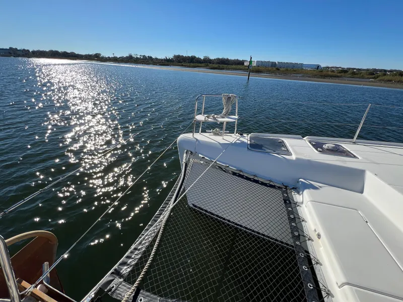 Slide: The Image of 2008 Lagoon 420 catamaran on calm water, sunny day, scenic view. - 34