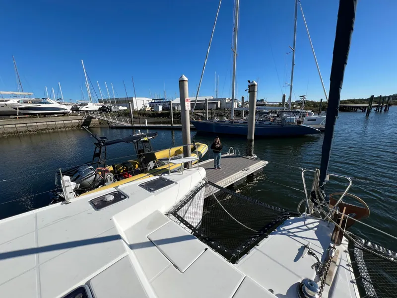 Slide: The Image of 2008 Lagoon 420 catamaran docked at marina with clear blue sky. - 35