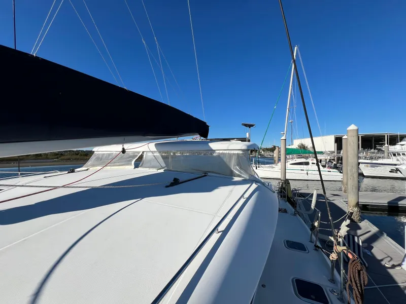 Slide: The Image of 2008 Lagoon 420 catamaran docked at marina under clear blue sky. - 36