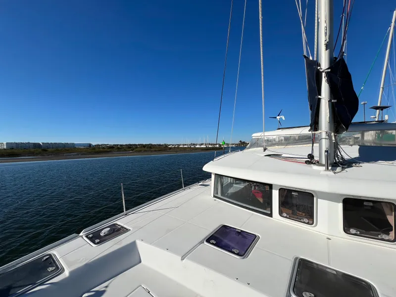 Slide: The Image of 2008 Lagoon 420 catamaran on calm water under clear blue sky. - 37