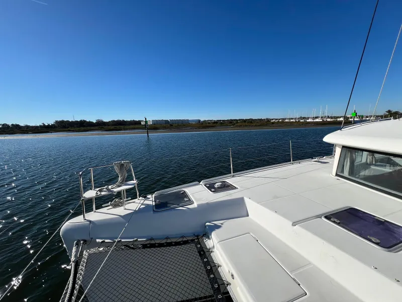 Slide: The Image of 2008 Lagoon 420 catamaran on calm waters under clear blue sky. - 38