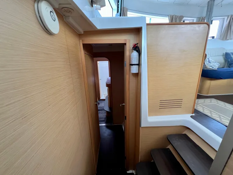 Slide: The Image of Interior hallway of a 2008 Lagoon 420 yacht with wooden paneling and stairs. - 42