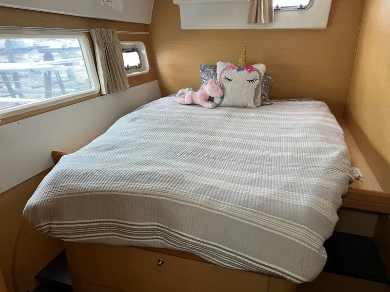 Slide: The Image of Interior of Lagoon 420 yacht with cozy bed and unicorn pillow. - 45