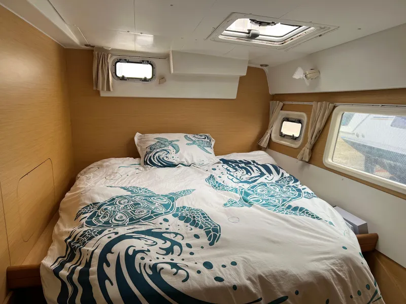 Slide: The Image of Interior of a 2008 Lagoon 420 yacht with bed and windows. - 49