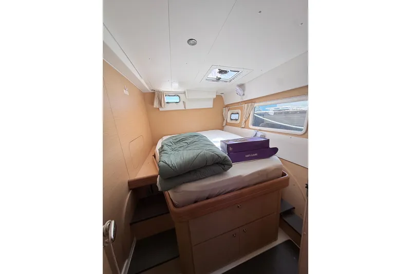 Slide: The Image of Interior cabin of a 2008 Lagoon 420 yacht with bed and storage. - 50