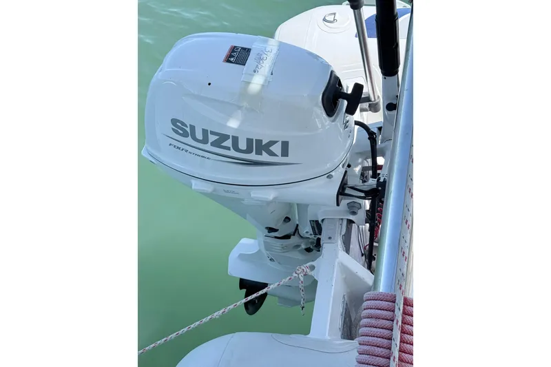 Slide: The Image of Suzuki outboard motor on 2008 Lagoon 420 boat, docked on calm water. - 6