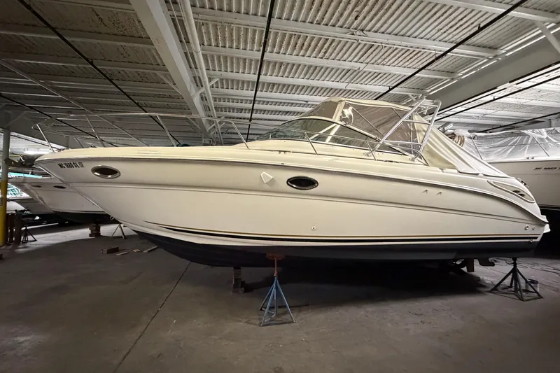 The Image of 2002 Sea Ray 290 Amberjack boat in indoor storage on stands. - 0