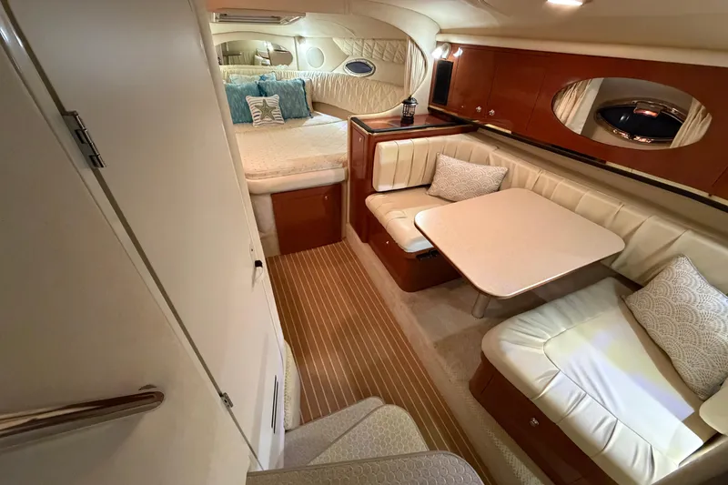 Slide: The Image of Luxurious interior of 2002 Sea Ray 290 Amberjack with cozy seating and elegant decor. - 10