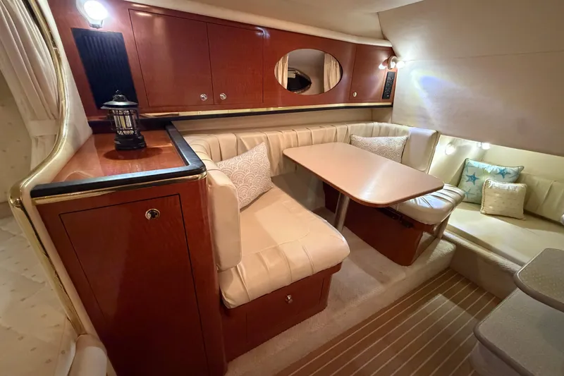 Slide: The Image of Luxurious interior of 2002 Sea Ray 290 Amberjack with elegant seating and wooden cabinetry. - 11