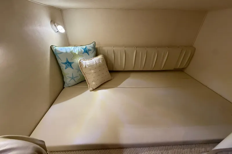 Slide: The Image of Cozy cabin interior of 2002 Sea Ray 290 Amberjack with decorative pillows. - 12