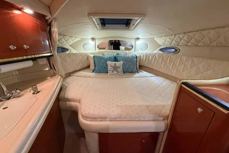 Slide: The Image of Luxurious cabin interior of 2002 Sea Ray 290 Amberjack with cozy bed and elegant decor. - 14