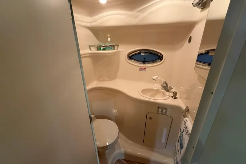 Slide: The Image of Bathroom interior of 2002 Sea Ray 290 Amberjack boat, featuring sink and toilet. - 15