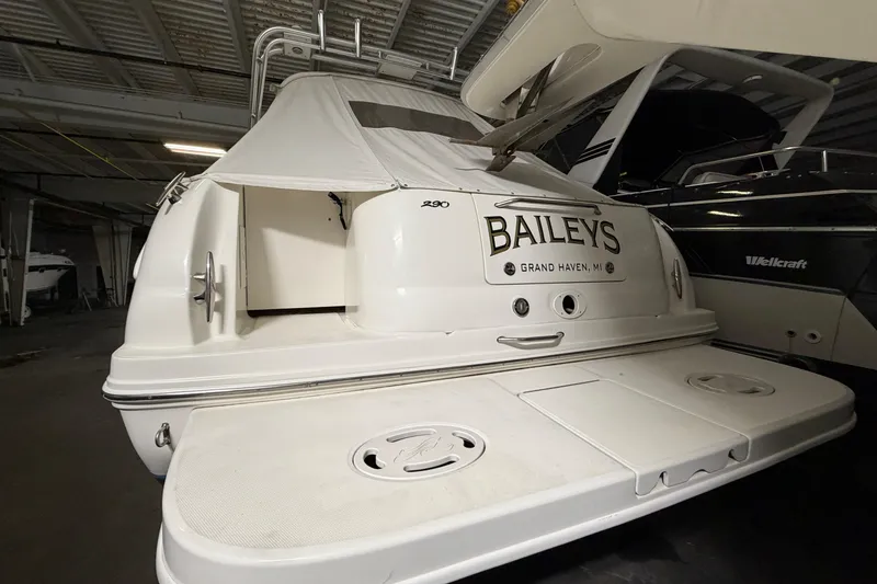 Slide: The Image of 2002 Sea Ray 290 Amberjack boat in storage, rear view with "Baileys" nameplate. - 2