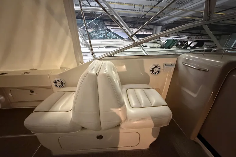 Slide: The Image of Interior of 2002 Sea Ray 290 Amberjack boat with white leather seating. - 7