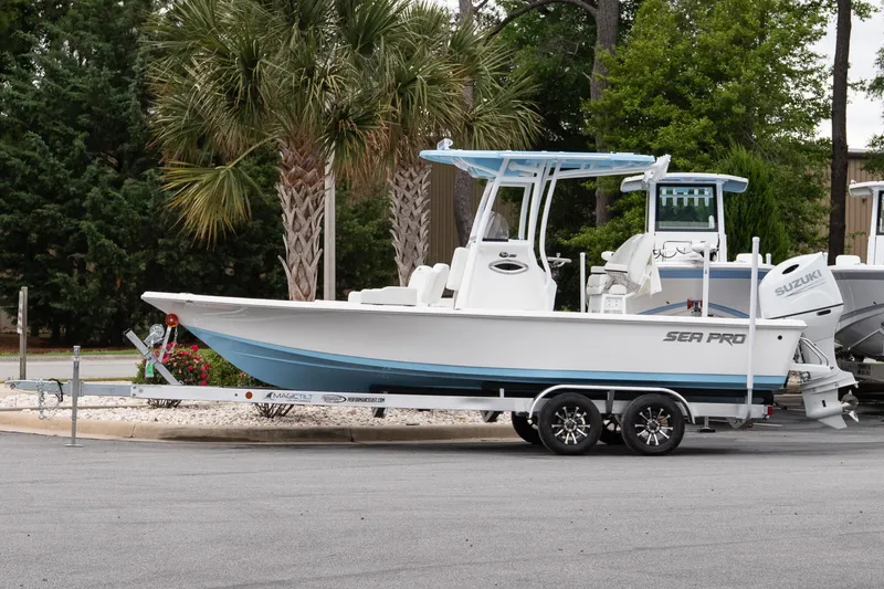 The Image of 2026 Sea Pro 230 Bay boat on trailer, parked near palm trees. - 1