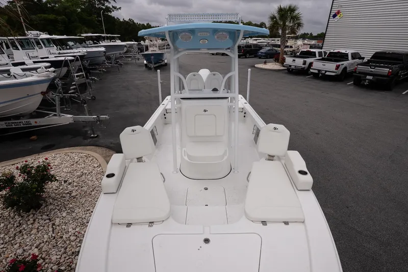 Slide: The Image of 2026 Sea Pro 230 Bay boat displayed in a dealership lot, showcasing seating and console. - 10