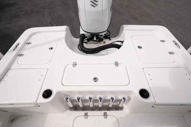Slide: The Image of 2026 Sea Pro 230 Bay boat deck with storage compartments and Suzuki outboard motor. - 12