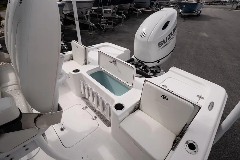Slide: The Image of 2026 Sea Pro 230 Bay boat interior with Suzuki engine and storage compartments. - 13
