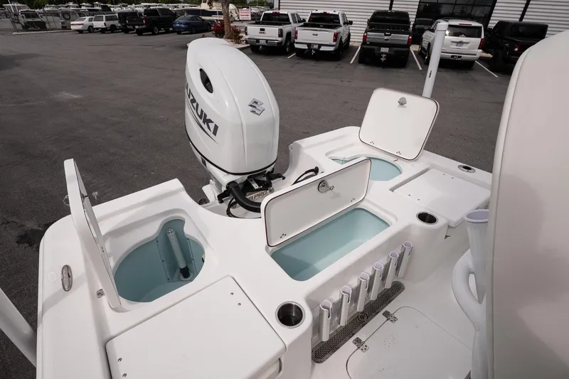 Slide: The Image of 2026 Sea Pro 230 Bay boat with Suzuki outboard motor and open storage compartments. - 14