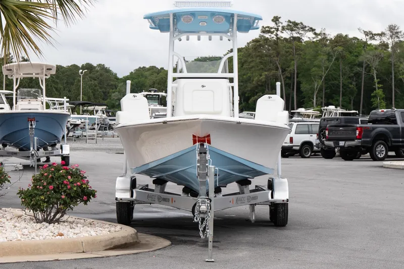 Slide: The Image of 2026 Sea Pro 230 Bay boat on trailer in parking lot, surrounded by greenery. - 3