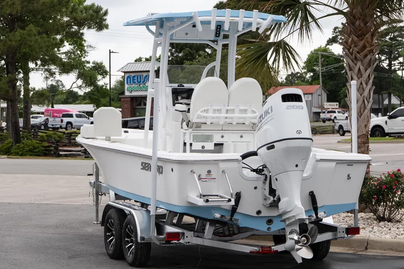 Slide: The Image of 2026 Sea Pro 230 Bay boat with Suzuki engine on trailer, parked outdoors. - 4