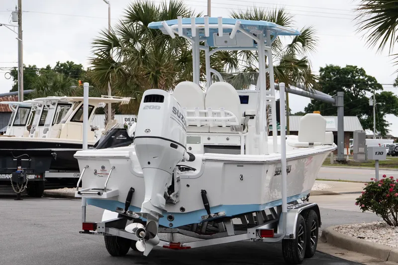 Slide: The Image of 2026 Sea Pro 230 Bay boat with Suzuki engine on trailer, parked outdoors. - 6
