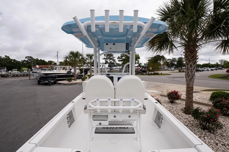 Slide: The Image of 2026 Sea Pro 230 Bay boat with T-top, parked near palm trees. - 7