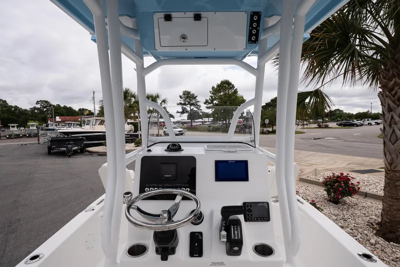 Slide: The Image of 2026 Sea Pro 230 Bay boat console with steering wheel and navigation equipment. - 8