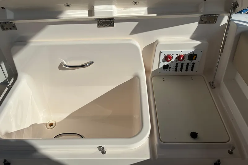 Slide: The Image of Interior view of 2015 Pursuit ST 310 Sport boat with beige seating and window. - 10