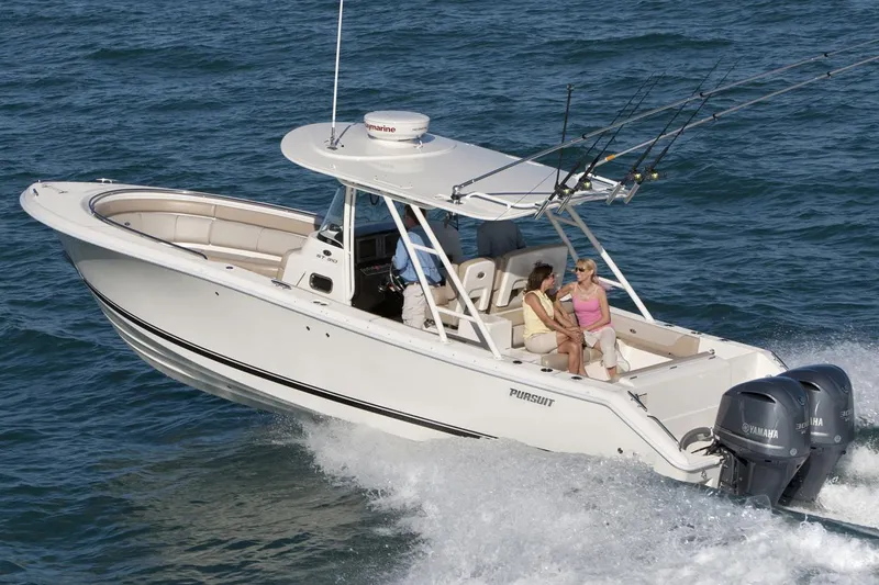 Slide: The Image of 2015 Pursuit ST 310 Sport boat compartment with control panel and storage area. - 14