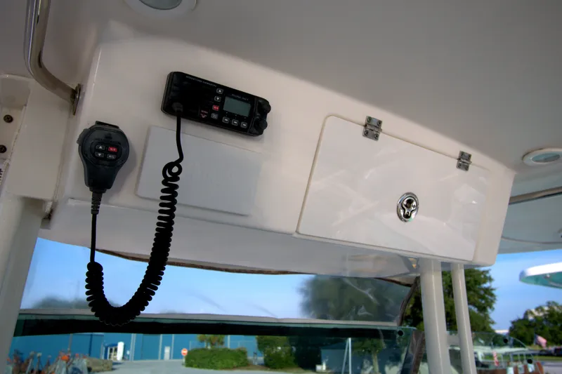 Slide: The Image of 2015 Pursuit ST 310 Sport boat interior with radio and storage compartment. - 45