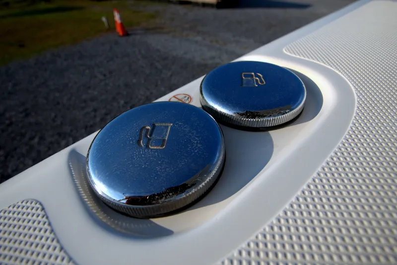 Slide: The Image of Chrome fuel caps on a 2015 Pursuit ST 310 Sport boat. - 19